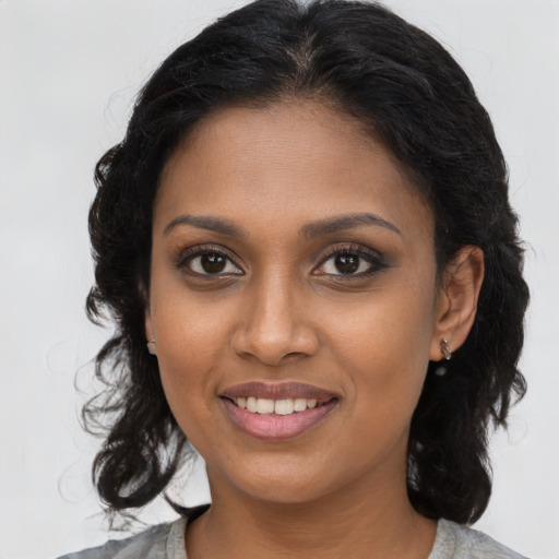 Joyful black young-adult female with medium  brown hair and brown eyes
