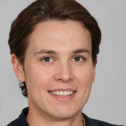 Joyful white adult male with short  brown hair and brown eyes