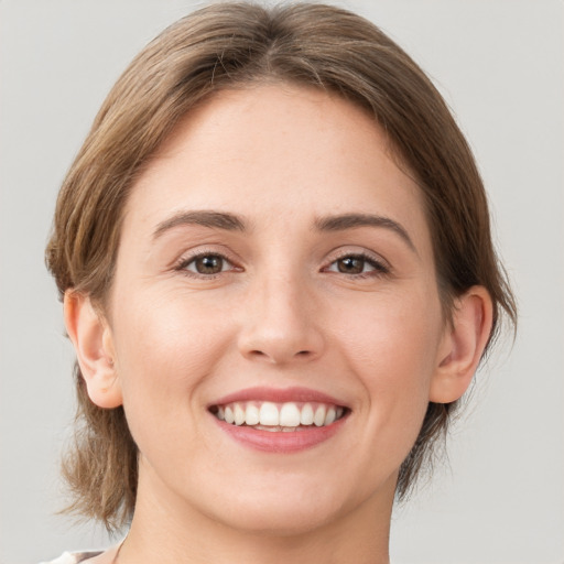 Joyful white young-adult female with medium  brown hair and brown eyes