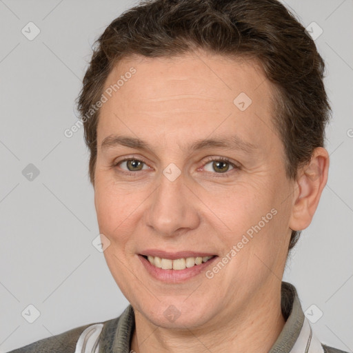 Joyful white adult female with short  brown hair and brown eyes