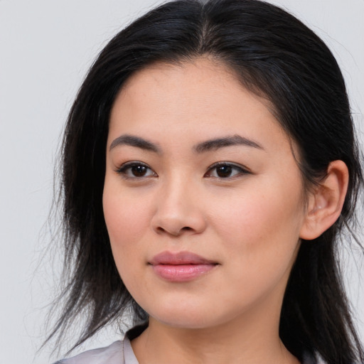 Joyful asian young-adult female with long  brown hair and brown eyes