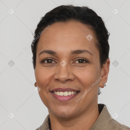 Joyful latino adult female with short  brown hair and brown eyes