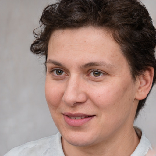 Joyful white adult female with medium  brown hair and brown eyes