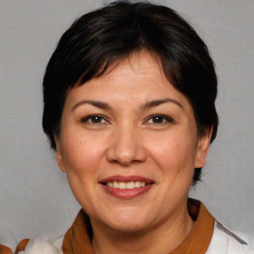 Joyful white adult female with medium  brown hair and brown eyes