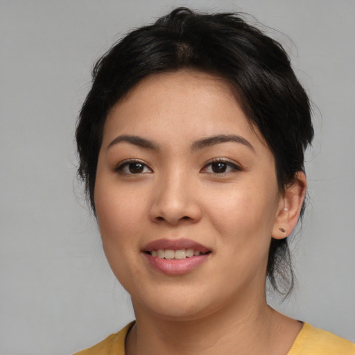 Joyful asian young-adult female with medium  brown hair and brown eyes