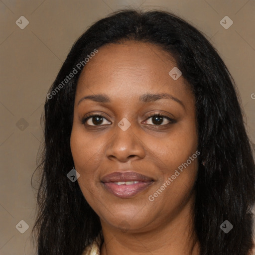 Joyful black adult female with long  brown hair and brown eyes