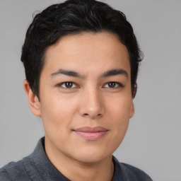 Joyful asian young-adult male with short  brown hair and brown eyes