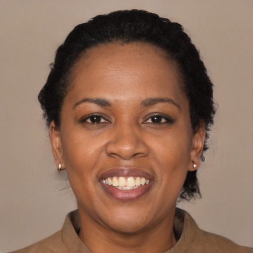 Joyful black young-adult female with short  brown hair and brown eyes