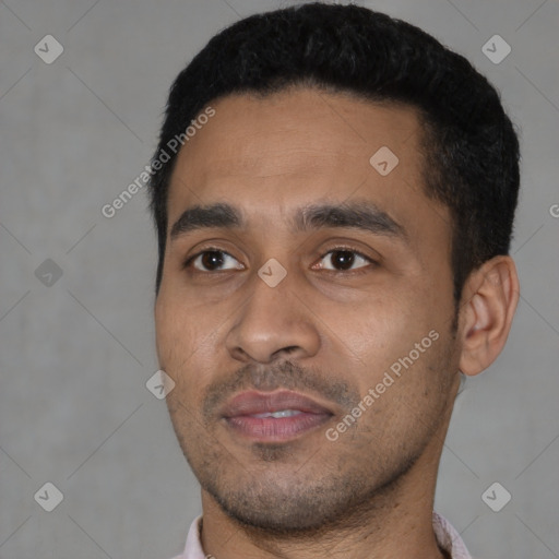 Joyful latino young-adult male with short  black hair and brown eyes