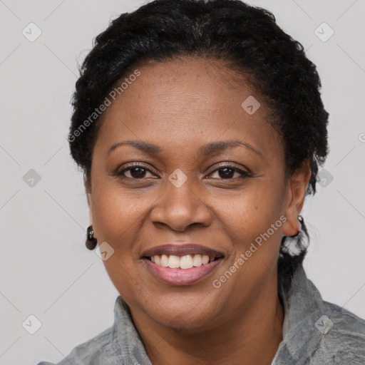 Joyful black adult female with short  brown hair and brown eyes