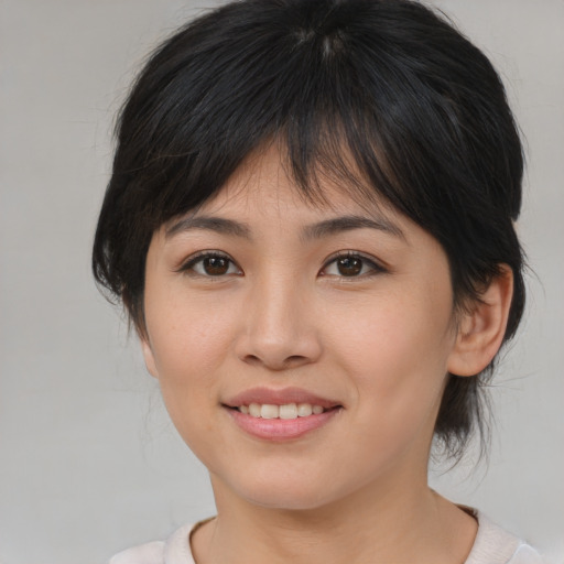 Joyful asian young-adult female with medium  brown hair and brown eyes