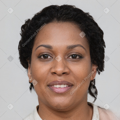 Joyful black adult female with short  brown hair and brown eyes