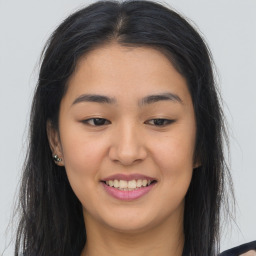 Joyful asian young-adult female with long  brown hair and brown eyes