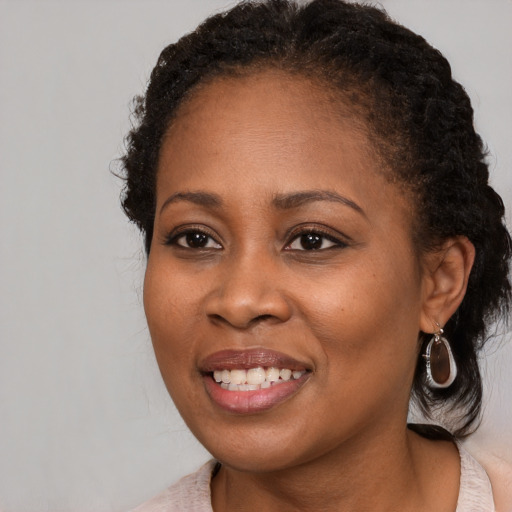 Joyful black young-adult female with medium  brown hair and brown eyes
