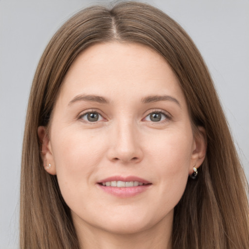 Joyful white young-adult female with long  brown hair and grey eyes