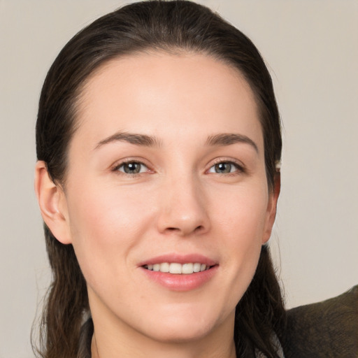 Joyful white young-adult female with medium  brown hair and brown eyes