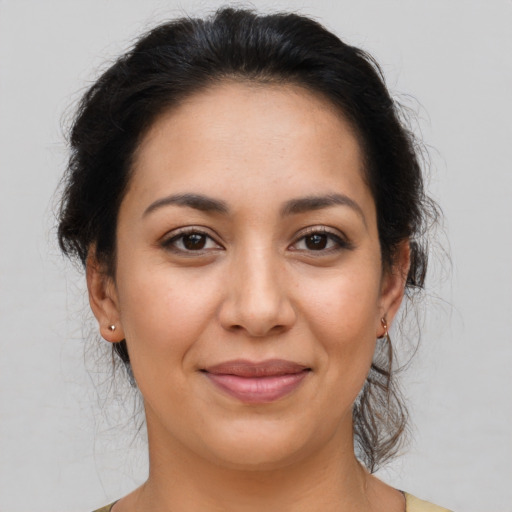 Joyful latino young-adult female with medium  brown hair and brown eyes