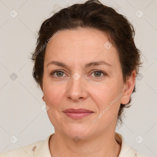 Joyful white adult female with medium  brown hair and green eyes