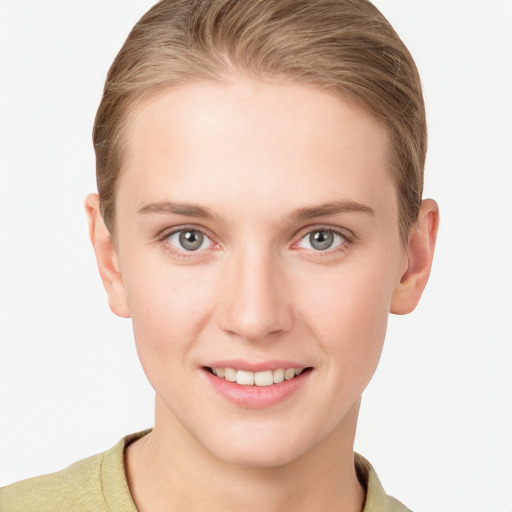 Joyful white young-adult female with short  brown hair and grey eyes