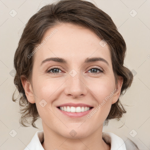 Joyful white young-adult female with medium  brown hair and green eyes