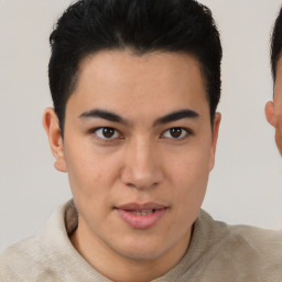 Joyful latino young-adult male with short  brown hair and brown eyes