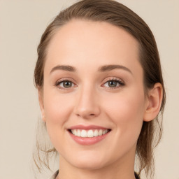 Joyful white young-adult female with medium  brown hair and blue eyes