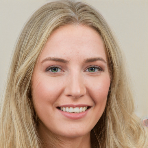 Joyful white young-adult female with long  brown hair and green eyes