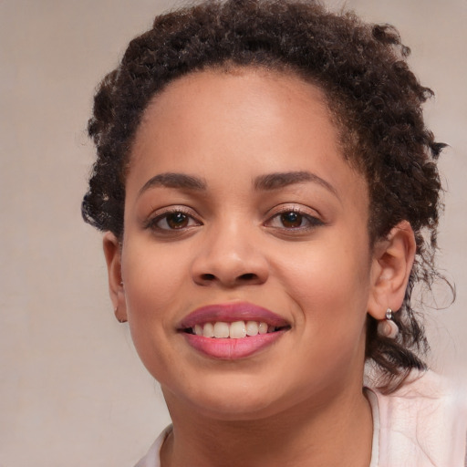 Joyful black young-adult female with medium  brown hair and brown eyes
