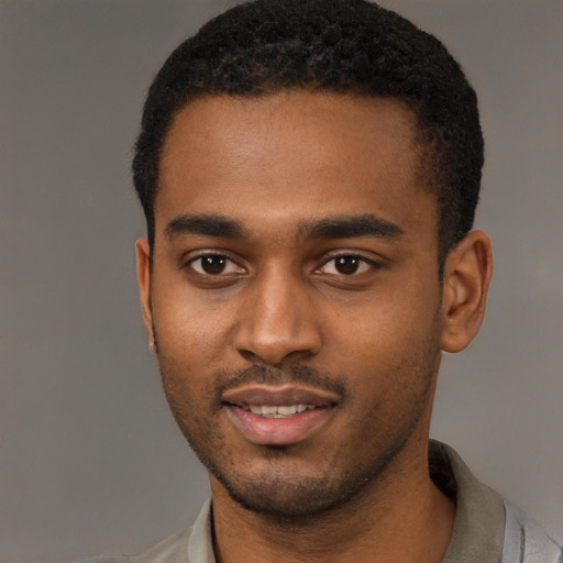 Joyful black young-adult male with short  black hair and brown eyes