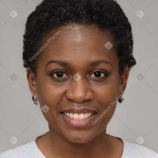 Joyful black young-adult female with short  brown hair and brown eyes