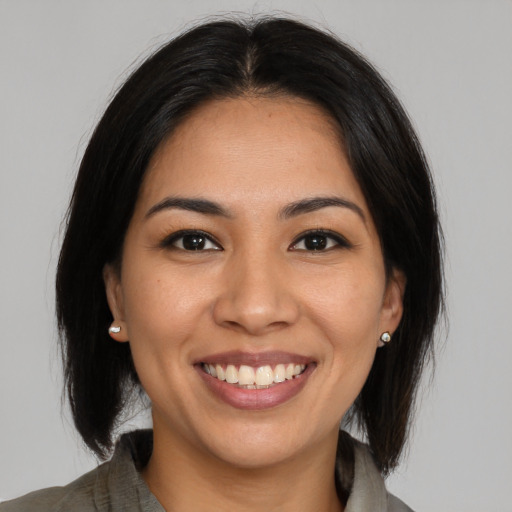 Joyful asian young-adult female with medium  brown hair and brown eyes