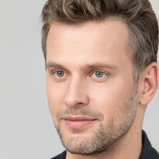 Joyful white adult male with short  brown hair and brown eyes