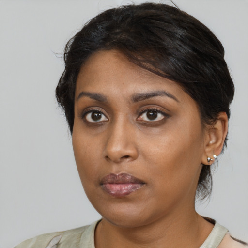 Neutral black young-adult female with medium  brown hair and brown eyes
