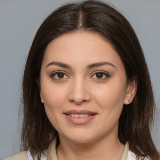 Joyful white young-adult female with medium  brown hair and brown eyes