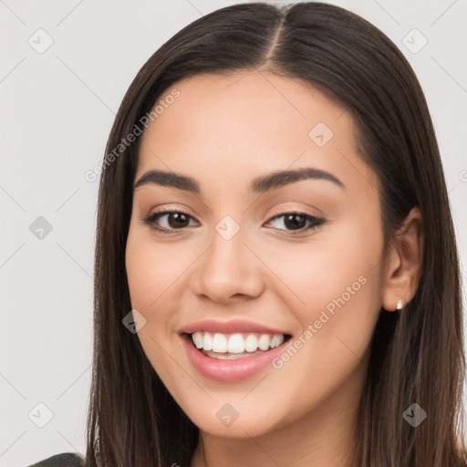 Joyful white young-adult female with long  brown hair and brown eyes