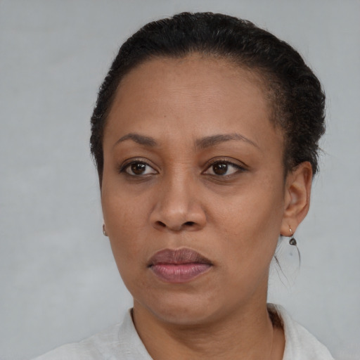 Joyful black adult female with short  brown hair and brown eyes