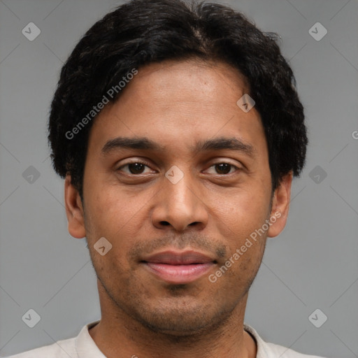 Joyful latino young-adult male with short  brown hair and brown eyes