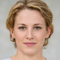 Joyful white young-adult female with medium  brown hair and blue eyes