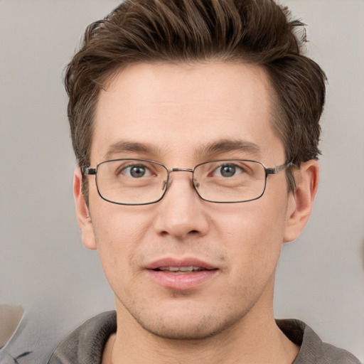 Joyful white adult male with short  brown hair and grey eyes