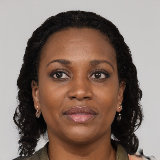 Joyful black adult female with medium  black hair and brown eyes
