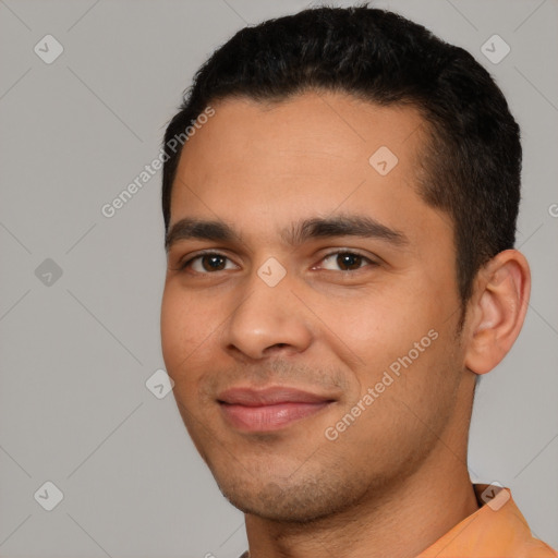 Joyful white young-adult male with short  black hair and brown eyes