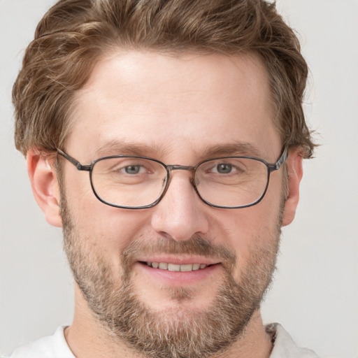 Joyful white adult male with short  brown hair and grey eyes