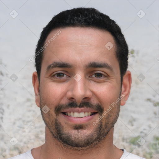 Joyful white young-adult male with short  black hair and brown eyes