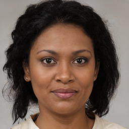 Joyful black adult female with medium  brown hair and brown eyes