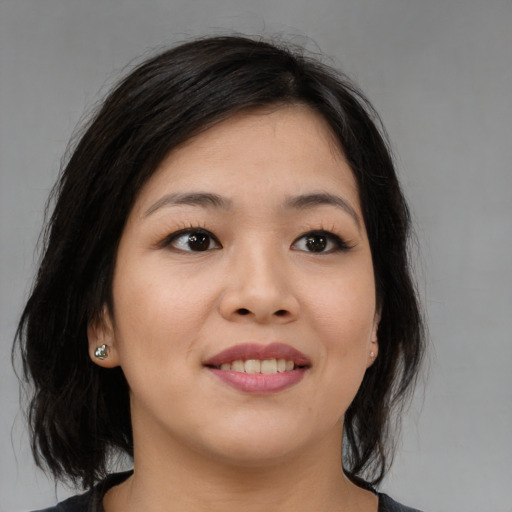 Joyful asian young-adult female with medium  brown hair and brown eyes