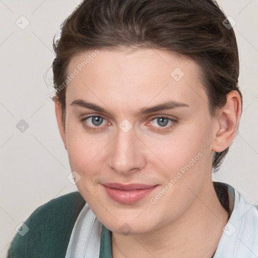 Joyful white young-adult female with short  brown hair and grey eyes