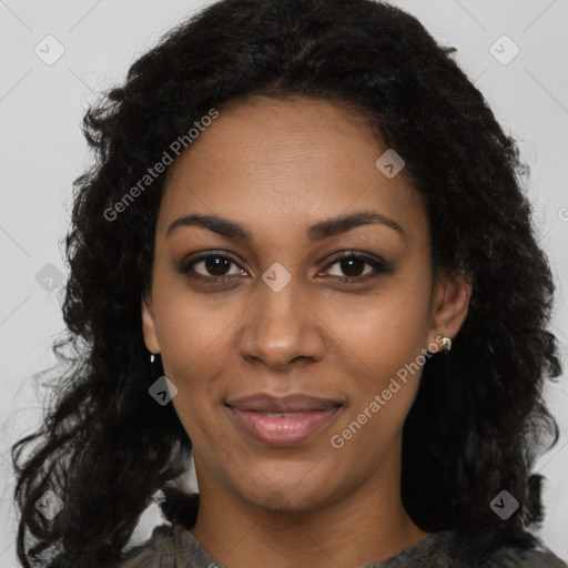 Joyful black young-adult female with long  black hair and brown eyes