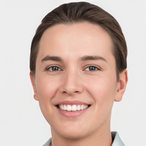 Joyful white young-adult female with short  brown hair and brown eyes