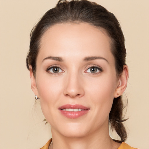 Joyful white young-adult female with medium  brown hair and brown eyes