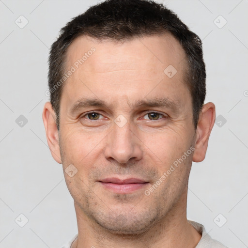 Joyful white adult male with short  brown hair and brown eyes